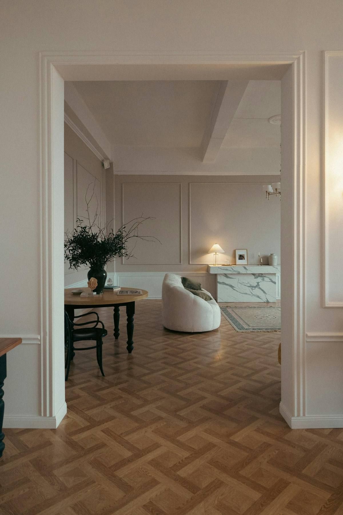 A parquet floor running into a bright living room